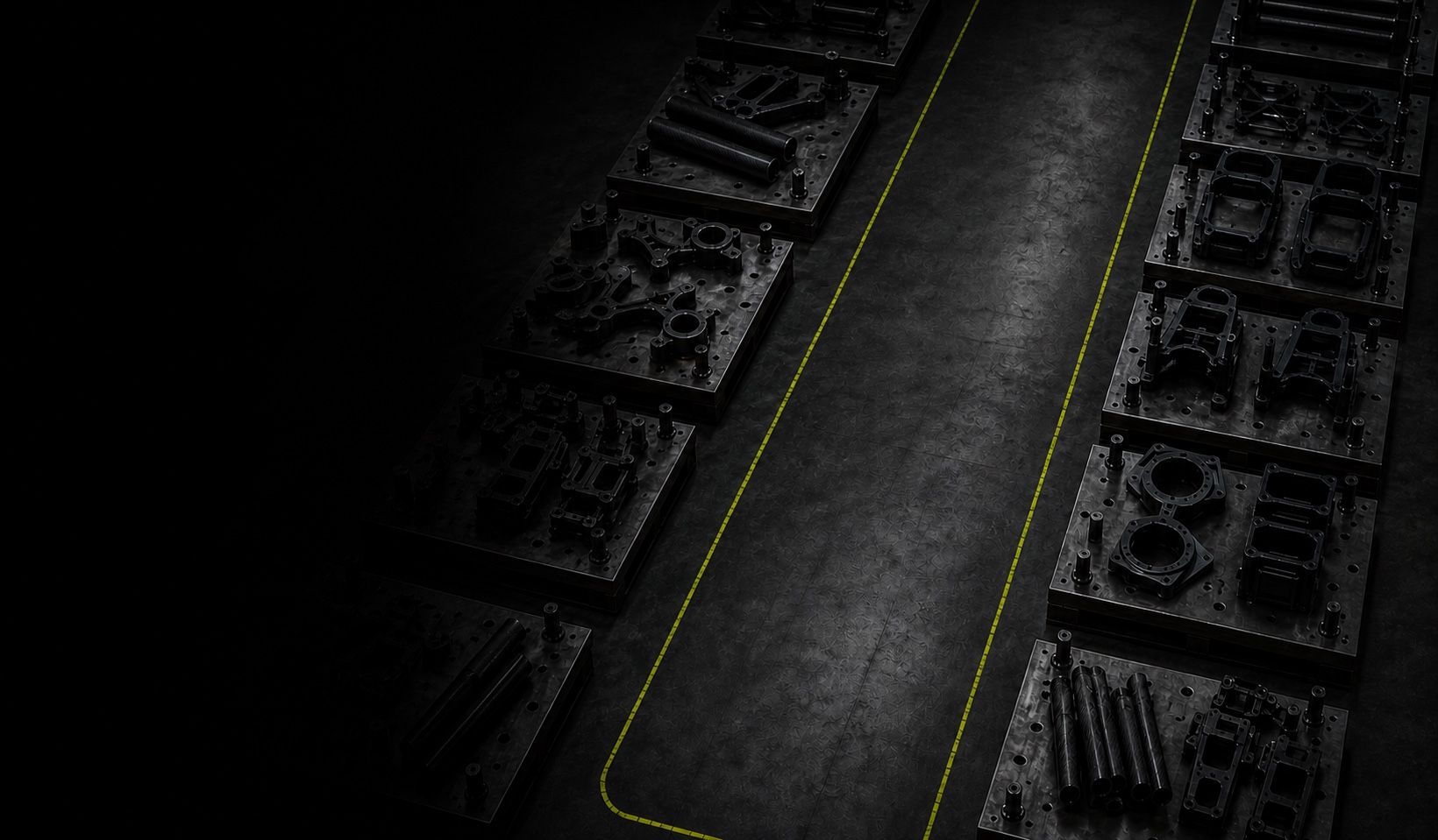 A symbolic empty production lane bordered by fixtures holding separate UAV component parts